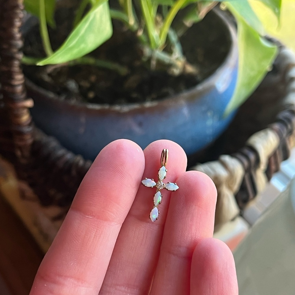 10kt cross with Ethiopian opals and a diamond in the center